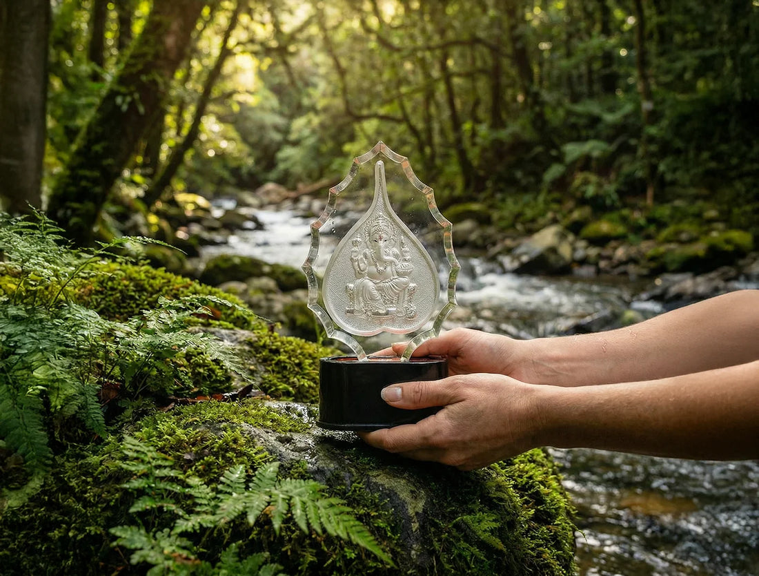 999 Pure Silver Ganesha Trophy Stand displayed in nature beside a flowing stream, showcasing detailed artwork.