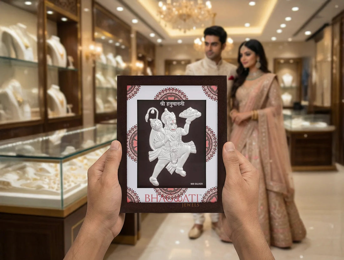 999 pure silver Hanumanji frame held in hands in a jewelry store with couple in traditional attire.