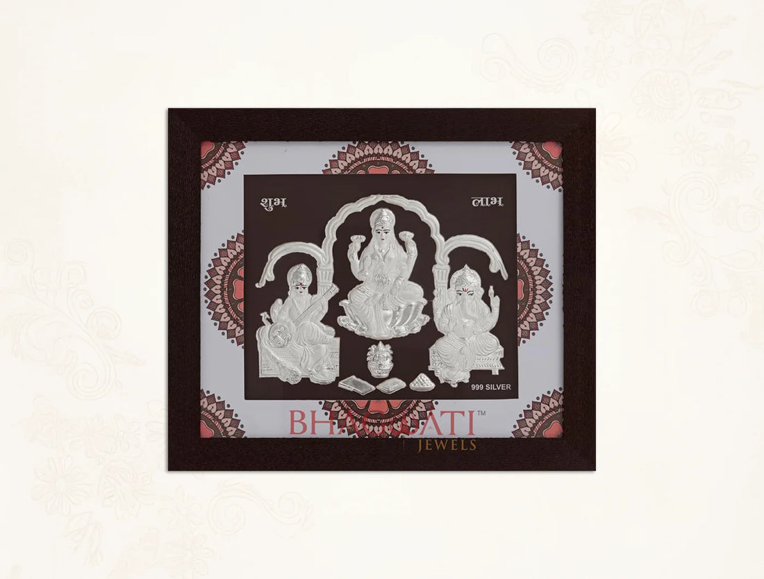 Square silver frame featuring Laxmi, Ganesh, and Saraswati images by Bhagwati Jewels, perfect for home or office decor.
