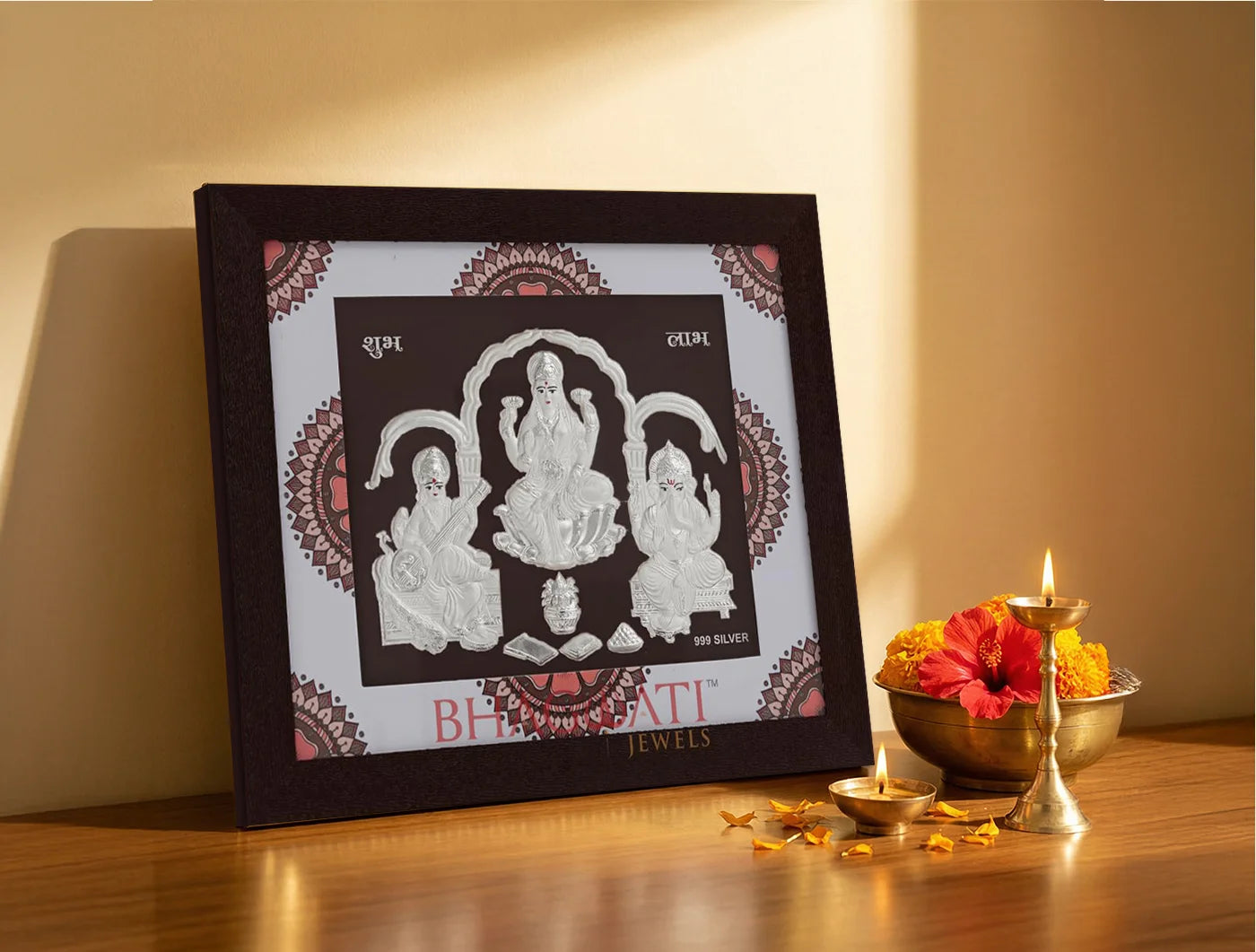 Silver frame featuring Laxmi Ganesh and Saraswati design by Bhagwati Jewels, 7x6 inch square photo for home or office decor.