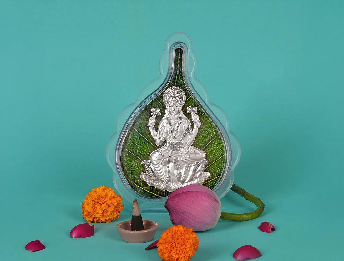 999 Pure Silver Laxmi Green Pan Stand displayed with flowers and a diya on a vibrant background.