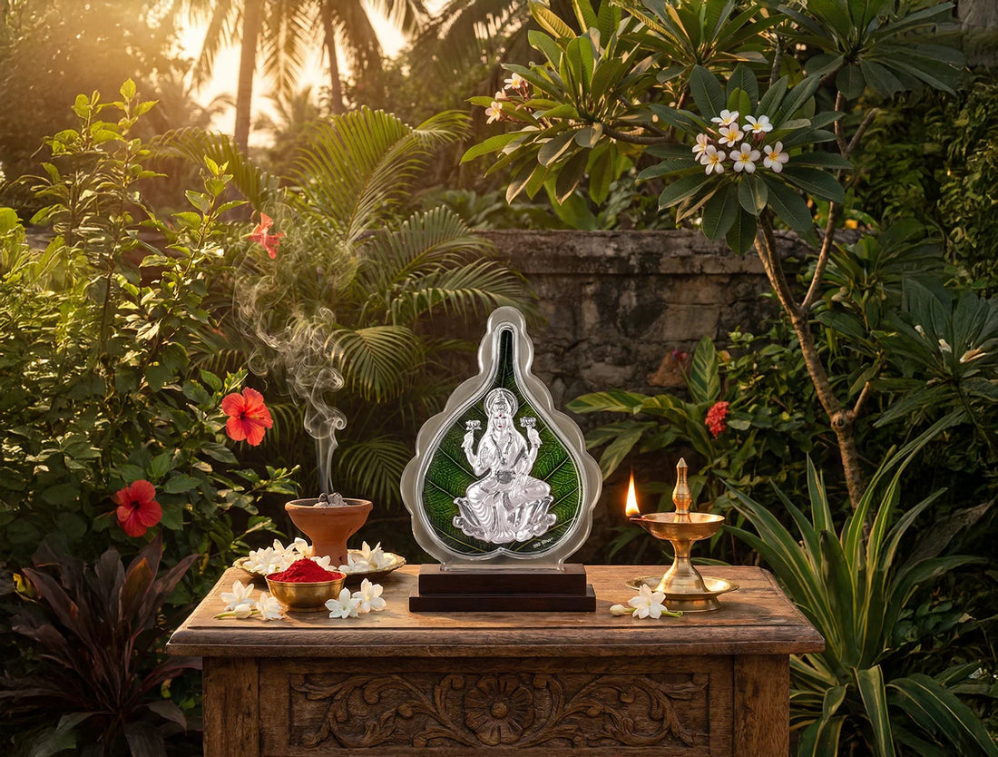 999 Pure Silver Laxmi Green Pan Stand on a wooden table in a lush garden setting with flowers and incense.