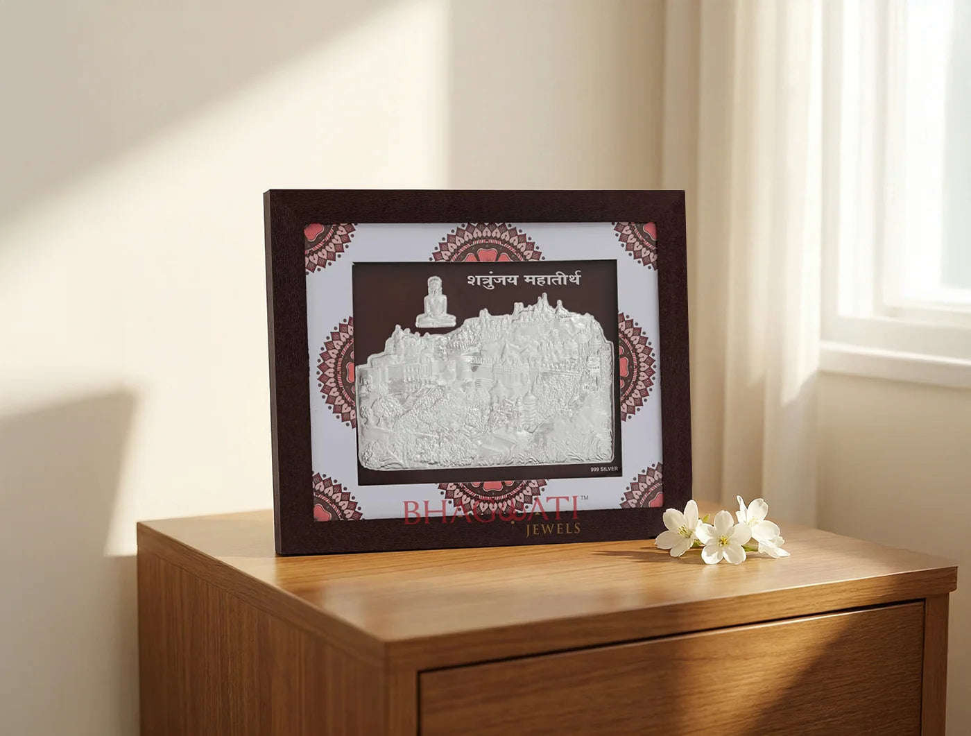 999 Pure Silver Shetrunjay Frame displayed elegantly on a wooden table with a flower beside it.