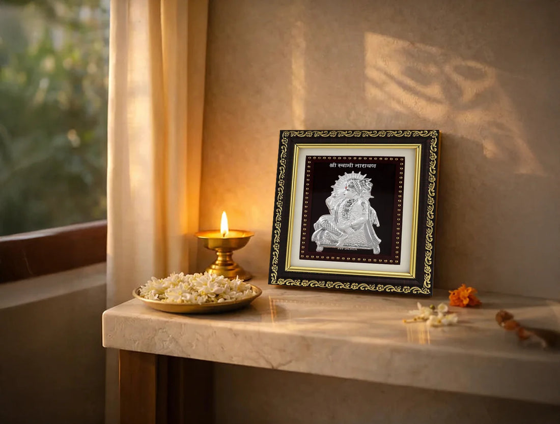 999 Pure Silver Swaminarayan photo frame displayed on a tabletop with flowers and a diya.