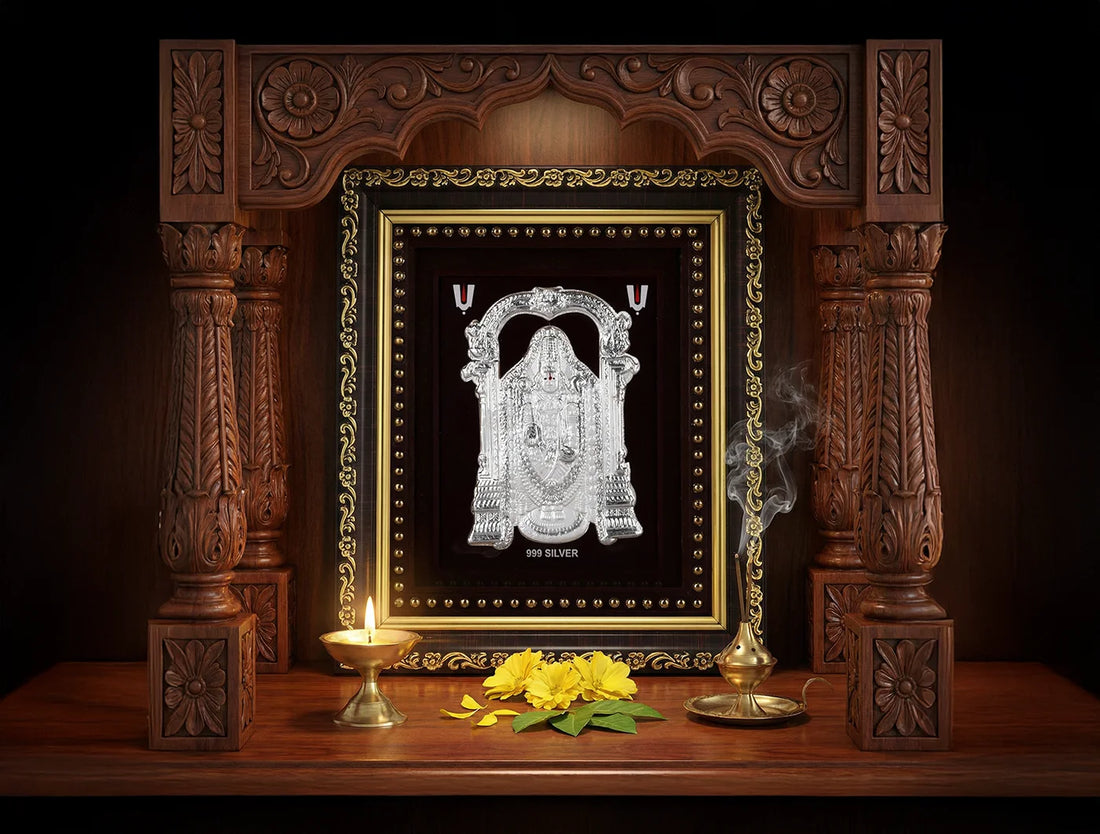 999 Pure Silver Tirupati Balaji photo frame displayed on a wooden altar with flowers and a lit lamp.